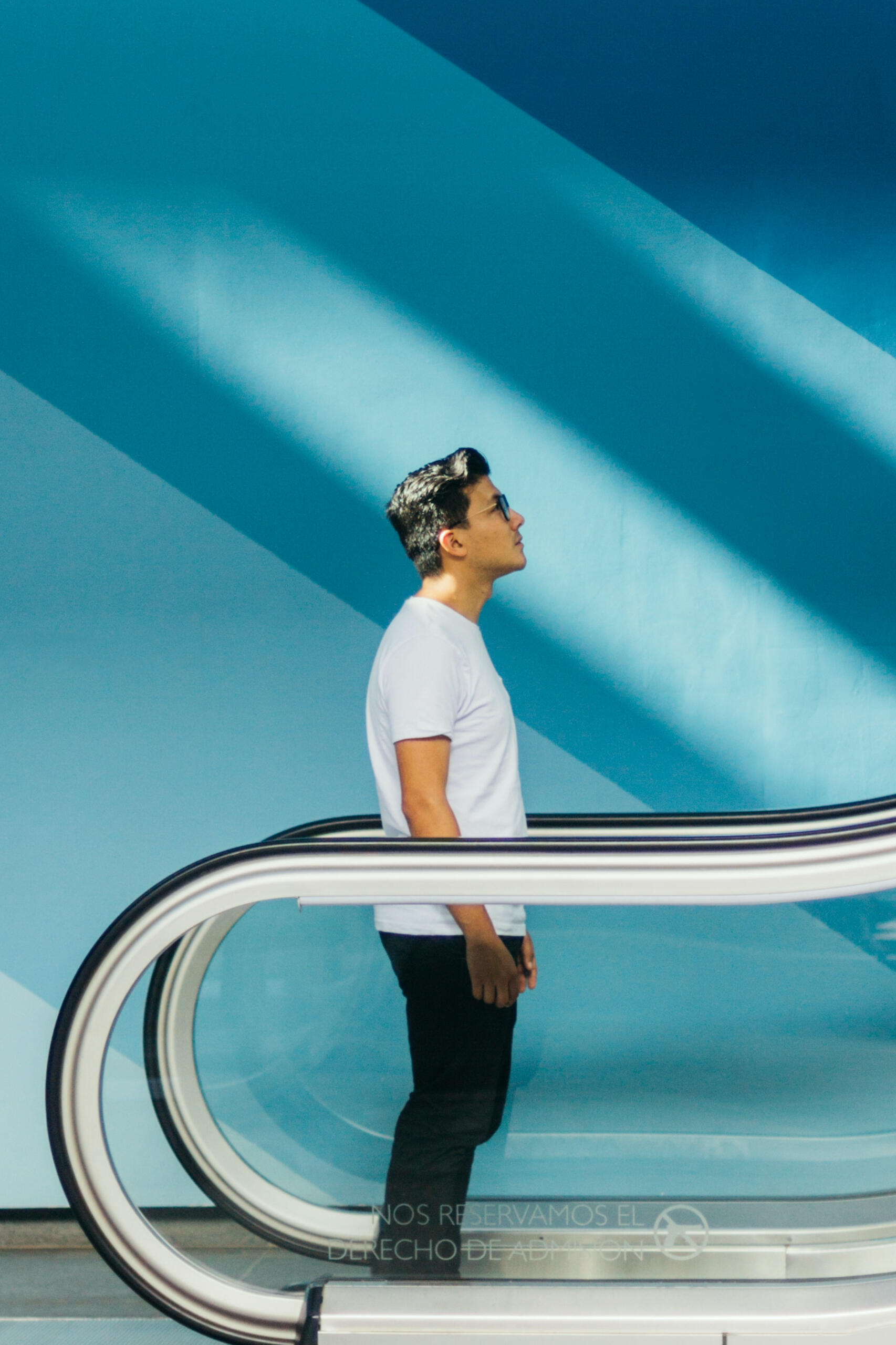 man going up an escalator